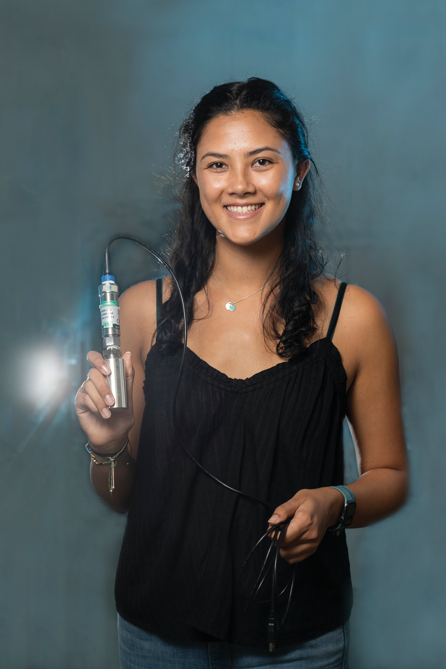 Brooke Chang holding an an isochoric chamber.