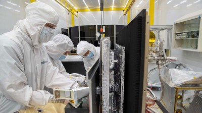 SDL Mechanical Engineering Associate Paul Fluckiger (left), Mechanical Engineer Trever Mitton (center), and JPL Cryogenic Thermal Subsystem Project Lead Weibo Chen prepare the CTS for delivery to JPL in this April 25, 2022 photo at SDL facilities in North Logan, Utah. Credit: SDL/Kelden Peterson