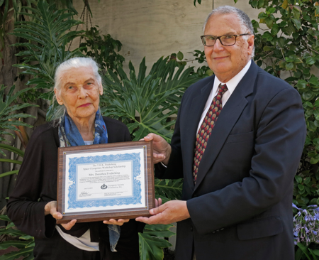 Lou Salerno presents Dorothea Frederking with a certificate establishing the SCW scholarship fund commemorating her late husband.