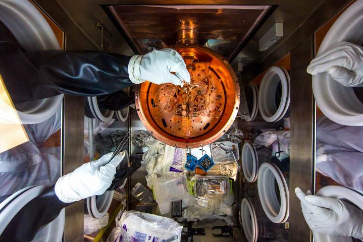 Researchers work on the delicate wiring of a cryostat. Image: Sanford Underground Research Facility, M. Kapust