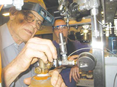 Prof. Smith and Dr. Teresa Peters work on a new "snowcream" apparatus at the MIT Cryogenics lab. Photo submitted by Dr. Teresa Peters.